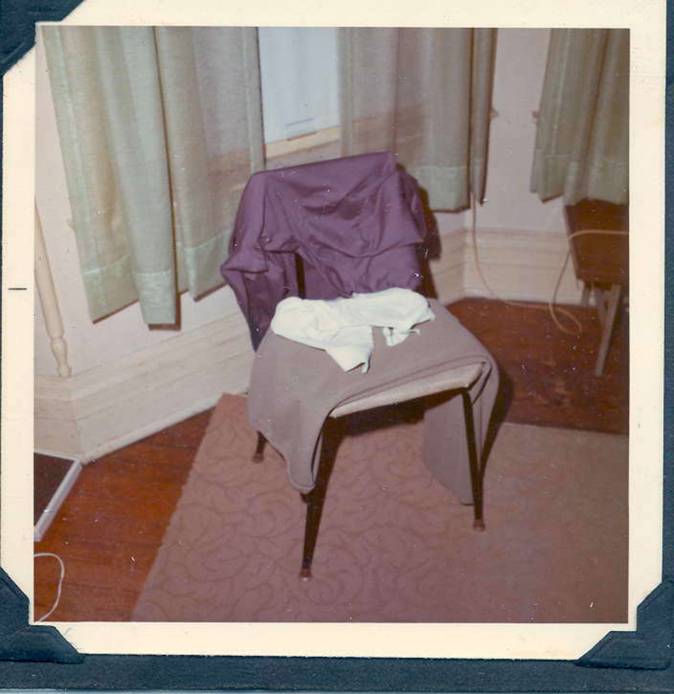 Women's clothes are seen draped over a chair.