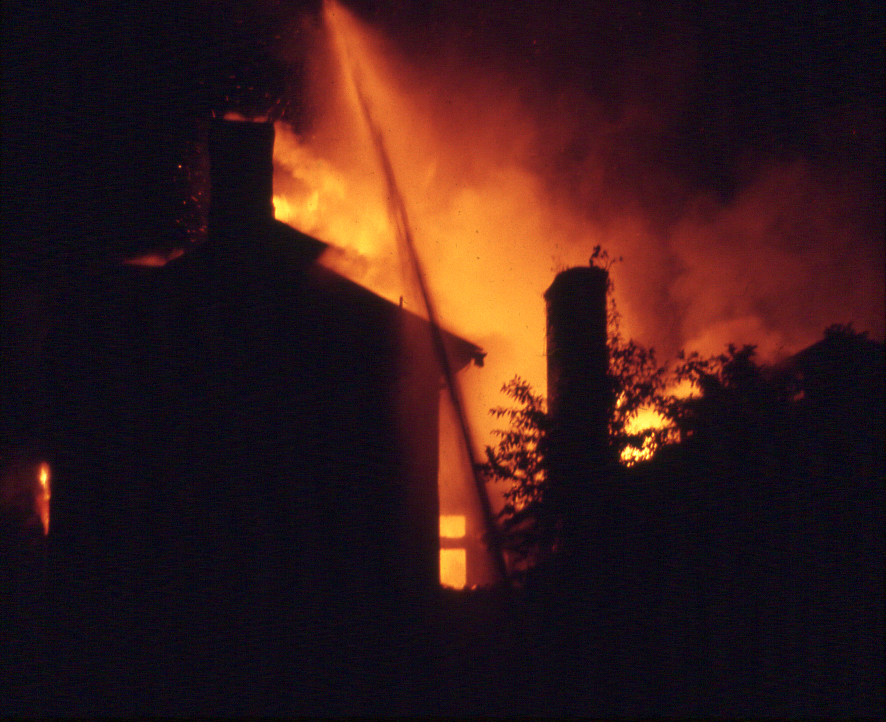 Firefighters spray water onto the rear of the mansion, with the ballroom at right, on Aug. 30, 1972. Photo by Nick Devlin.