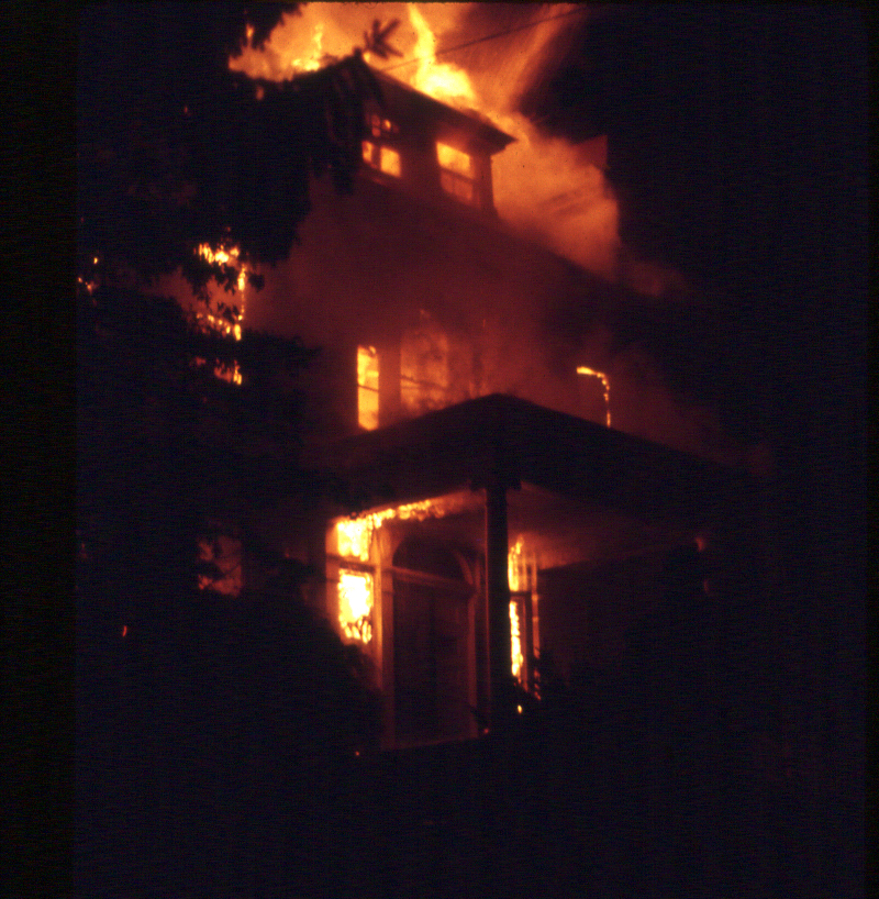 Flames highlight the front doorway of Breeze Knoll on Aug. 30, 1972. Photo by Nick Devlin.